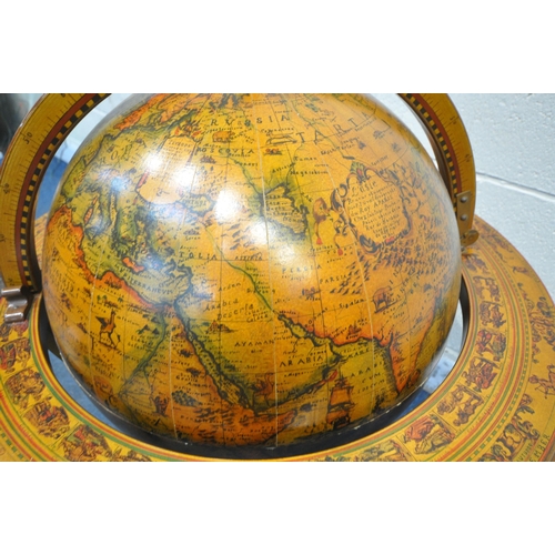 1226 - A 20TH CENTURY DRINKS GLOBE, the hinged top enclosing a fitted interior, on turned legs united by a ... 