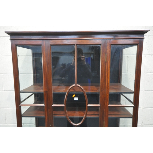 1227 - AN EARLY 20TH CENTURY MAHOGANY SINGLE DOOR DISPLAY CABINET, enclosing three shelves, on square taper... 