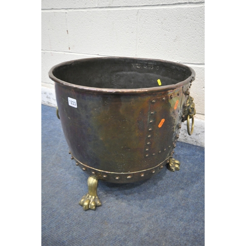 1233 - A 19TH CENTURY RIVETED BRASS AND COPPER COAL BUCKET, with lions head handles, and triple paw feet, d... 