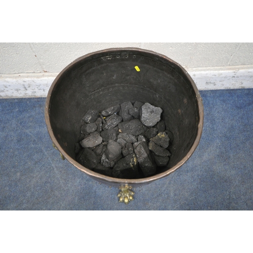 1233 - A 19TH CENTURY RIVETED BRASS AND COPPER COAL BUCKET, with lions head handles, and triple paw feet, d... 