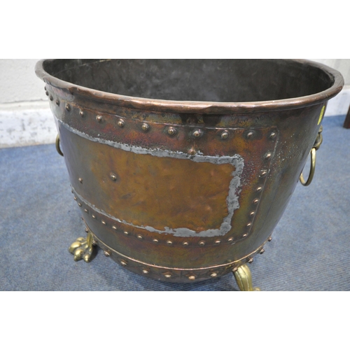 1233 - A 19TH CENTURY RIVETED BRASS AND COPPER COAL BUCKET, with lions head handles, and triple paw feet, d... 