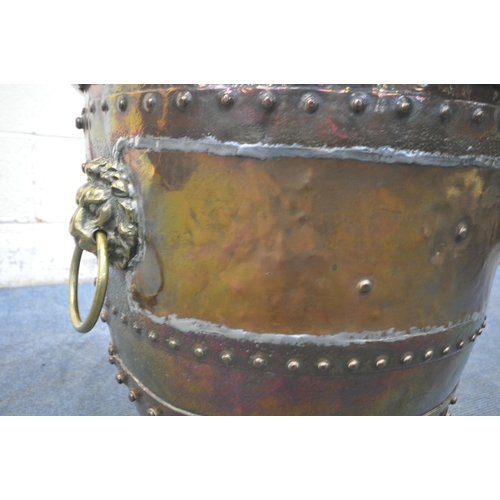 1233 - A 19TH CENTURY RIVETED BRASS AND COPPER COAL BUCKET, with lions head handles, and triple paw feet, d... 