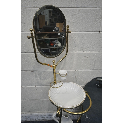 1238 - AN EARLY TO MID 20TH CENTURY BRASS FRAMED WASHSTAND, with an oval swinging mirror, ceramic jug, bowl... 