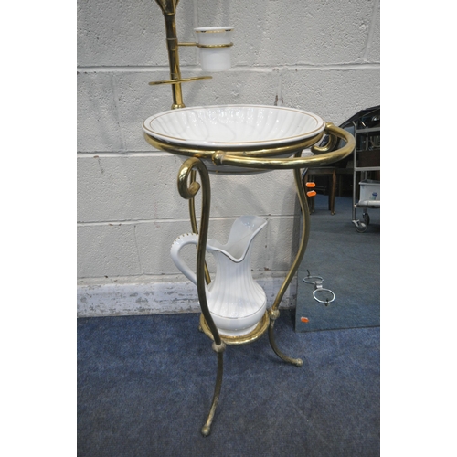 1238 - AN EARLY TO MID 20TH CENTURY BRASS FRAMED WASHSTAND, with an oval swinging mirror, ceramic jug, bowl... 