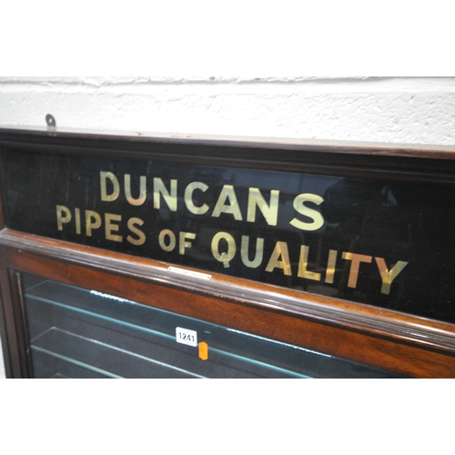 1241 - AN EARLY 20TH CENTURY MAHOGANY SINGLE DOOR DUNCAN'S PIPES OF QUALITY DISPLAY CASE, enclosing seven g... 