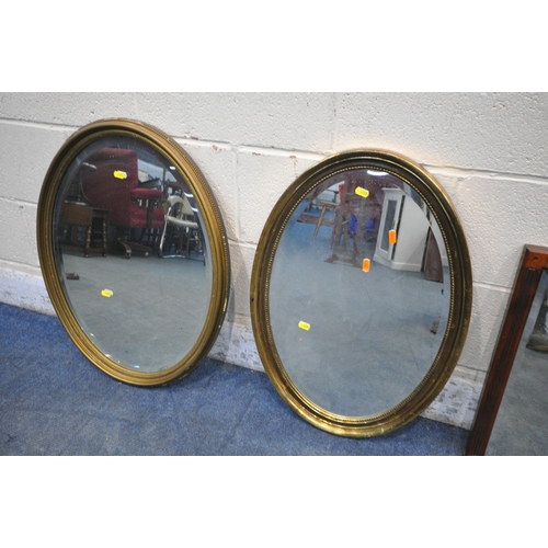 1255 - FIVE VARIOUS OVAL MIRRORS, to include two gilt framed mirrors, and three mahogany mirrors, along wit... 