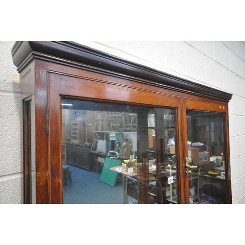 1264 - AN EARLY 20TH CENTURY NARROW MAHOGANY GLAZED TWO DOOR COLLECTORS DISPLAY CABINET, enclosing ten glas... 