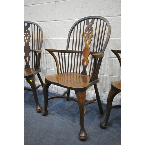 1286 - A SET OF FOUR EARLY 20TH CENTURY ELM AND BEECH HOOP BACK WINDSOR ARMCHAIR, with a wheel splat back, ... 