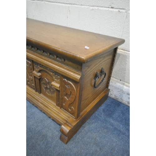 1302 - A CARVED OAK BLANKET CHEST, with iron drop handles, width 123cm x depth 49cm x height 47cm (conditio... 