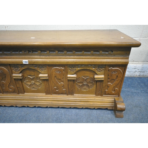 1302 - A CARVED OAK BLANKET CHEST, with iron drop handles, width 123cm x depth 49cm x height 47cm (conditio... 