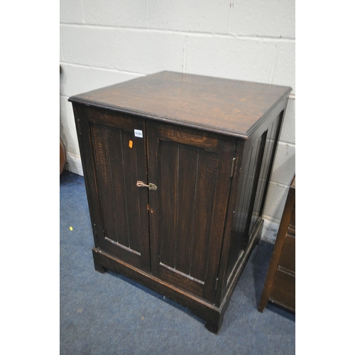 1311 - AN OAK PANELLED TWO DOOR CUPBOARD, 67cm squared x height 89cm, and an oak dressing chest with three ... 