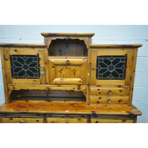 1312 - A PINE DRESSER, the top made up in an arrangement of drawers and cupboard, above a base with three d... 