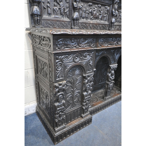 1327 - A 19TH CENTURY HEAVILY CARVED OAK SIDEBOARD, the raised back with panelling and shelf, fitted with t... 