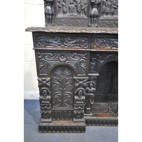 1327 - A 19TH CENTURY HEAVILY CARVED OAK SIDEBOARD, the raised back with panelling and shelf, fitted with t... 