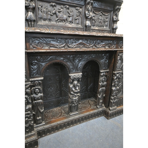 1327 - A 19TH CENTURY HEAVILY CARVED OAK SIDEBOARD, the raised back with panelling and shelf, fitted with t... 