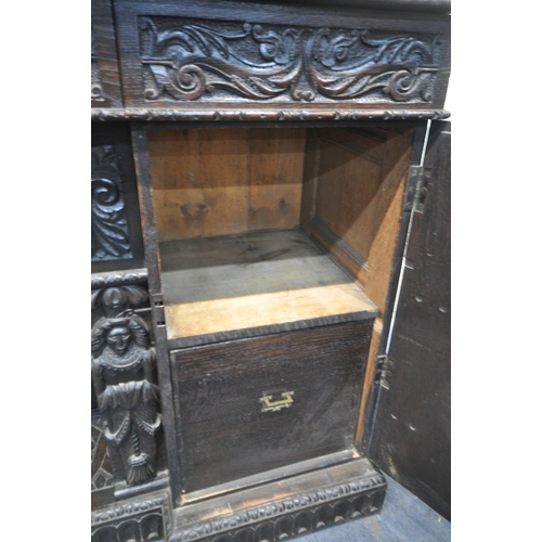 1327 - A 19TH CENTURY HEAVILY CARVED OAK SIDEBOARD, the raised back with panelling and shelf, fitted with t... 