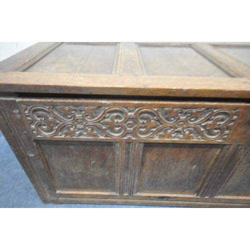 1341 - A GEORGIAN OAK PANELLED COFFER, with a hinged lid and carved details to the front, width 159cm x dep... 