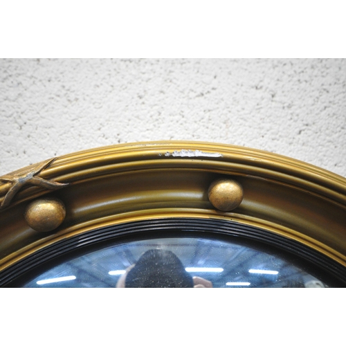 1351 - A GILT RESIN OVAL BEVELLED EDGE WALL MIRROR, with foliate details, 90cm x 69cm, a Regency style conv... 