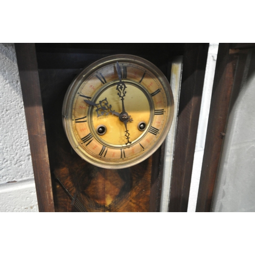 1363 - TWO 19TH CENTURY VIENNA WALL CLOCKS, each clock with an arched glass door, that's enclosing an ename... 