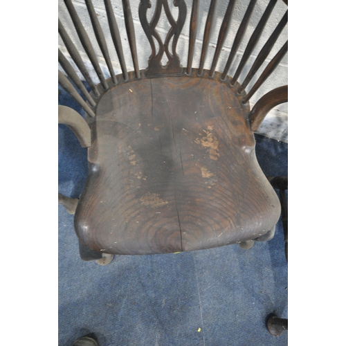 1366 - A SET OF FOUR ELM ARMCHAIRS, with shaped crest, spindle supports, central splat back, raised on fron... 