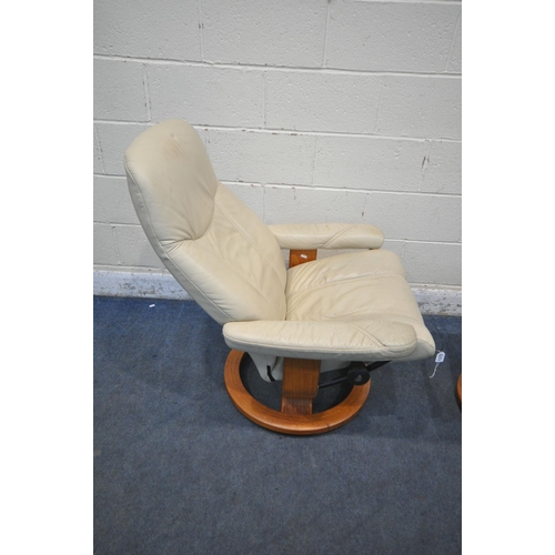 1377 - AN EKORNES STRESSLESS CREAM LEATHER SWIVEL RECLINING ARMCHAIR, along with a footstool (condition rep... 