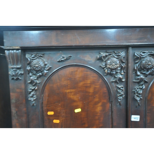 1402 - A NEAR PAIR OF VICTORIAN MAHOGANY DOUBLE DOOR WARDROBES, with foliate moulding, one wardrobe enclosi... 