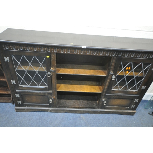 1406 - AN EARLY 20TH CENTURY OAK BOOKCASE, with double lead glazed doors, double cupboard doors, flanking t... 