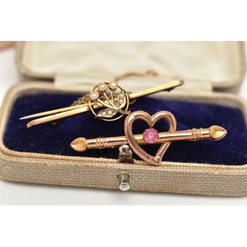 10 - TWO EARLY 20TH CENTURY BROOCHES, the first an open work heart with bar set with a single pink paste ... 