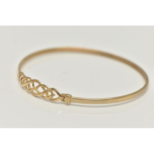 17 - A 9CT GOLD BANGLE, a Celtic design light weight bangle, fitted with a hook fastening, hallmarked 9ct... 