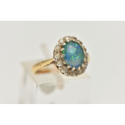 22 - AN 18CT GOLD SYNTHETIC OPAL AND DIAMOND CLUSTER RING, the central oval synthetic opal cabochon withi... 