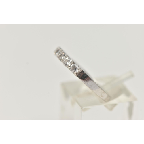 26 - A 9CT WHITE GOLD CUBIC ZIRCONIA RING, designed as a line of seven circular cubic zirconia stones, to... 