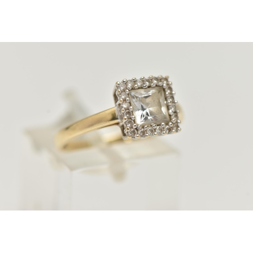 28 - A 14CT GOLD GEM SET RING, the square shape colourless gem within a circular gem surround, gems asses... 