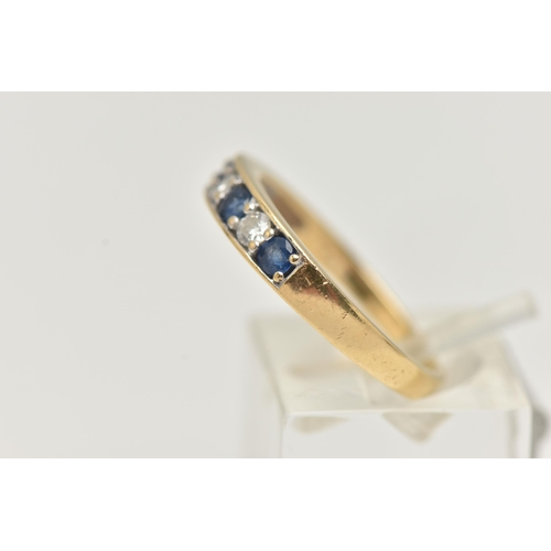 31 - AN 18CT GOLD SAPPHIRE AND DIAMOND SEVEN STONE RING, designed as a line of four circular sapphires in... 