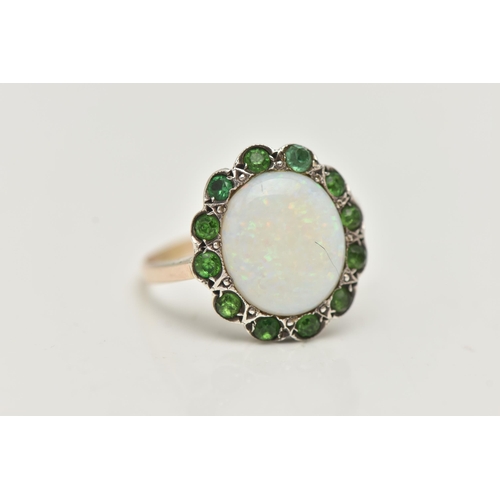 32 - AN OPAL RING, the central opal cabochon within a green gem surround, assessed as green paste, unmark... 