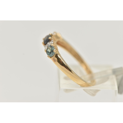 36 - A 14CT GEMSTONE RING, designed as three oval cut green gems, assessed as topaz, interspaced by a tot... 