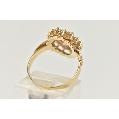 39 - A DRESS RING, designed as a central pear shape peach cubic zirconia within a colourless circular cub... 