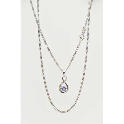 47 - A TANZANITE AND DIAMOND PENDANT AND 9CT WHITE GOLD CHAIN, the pendant designed as a circular tanzani... 