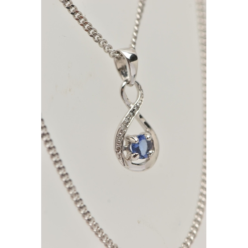 47 - A TANZANITE AND DIAMOND PENDANT AND 9CT WHITE GOLD CHAIN, the pendant designed as a circular tanzani... 