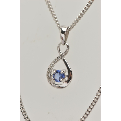 47 - A TANZANITE AND DIAMOND PENDANT AND 9CT WHITE GOLD CHAIN, the pendant designed as a circular tanzani... 