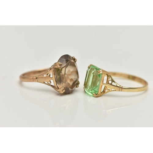 55 - TWO YELLOW METAL GEM SET RINGS, the first set with an oval cut smoky quartz, in a double four claw s... 