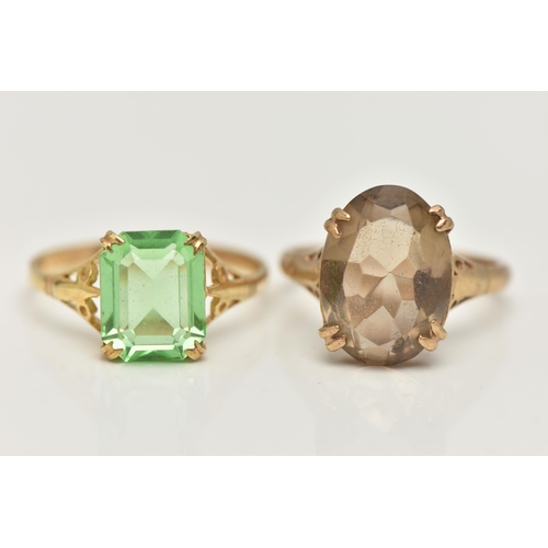 55 - TWO YELLOW METAL GEM SET RINGS, the first set with an oval cut smoky quartz, in a double four claw s... 