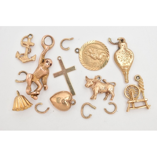 106 - A SMALL BAG OF 9CT GOLD CHARMS, to include a bull, bell, bellowers, anchor, St. Christopher, cross, ... 