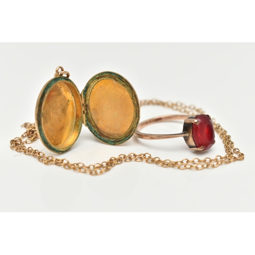 134 - A YELLOW METAL RING, CHAIN AND OVAL LOCKET, the ring set with a rubbed and worn, oval cut red paste,... 