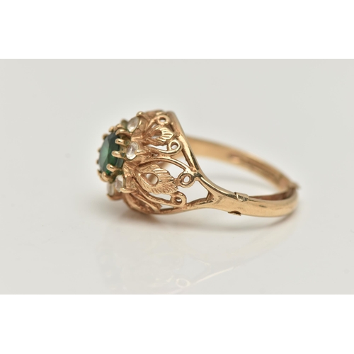 70 - A 9CT GOLD GEM SET RING, the central circular gem possibly a soude emerald, with circular colourless... 