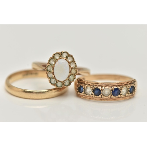 75 - THREE 9CT GOLD GEM SET RINGS, to include an opal and colourless gem cluster ring, a seven stone sapp... 