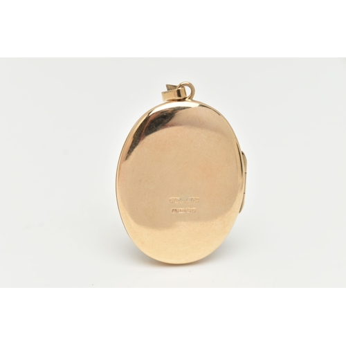 90 - A 9CT GOLD OVAL LOCKET, floral pattern, hallmarked 9ct Birmingham, fitted with a tapered bail, lengt... 