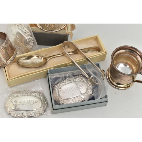 174 - AN ASSORTMENT OF SILVER, to include two silver napkin rings, a miniature tankard, a pair of sugar to... 