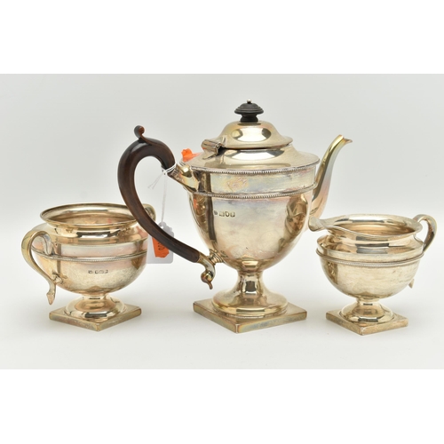 183 - AN EARLY 20TH CENTURY SILVER THREE PIECE TEA SET, comprising of a teapot, sugar bowl and milk jug, e... 