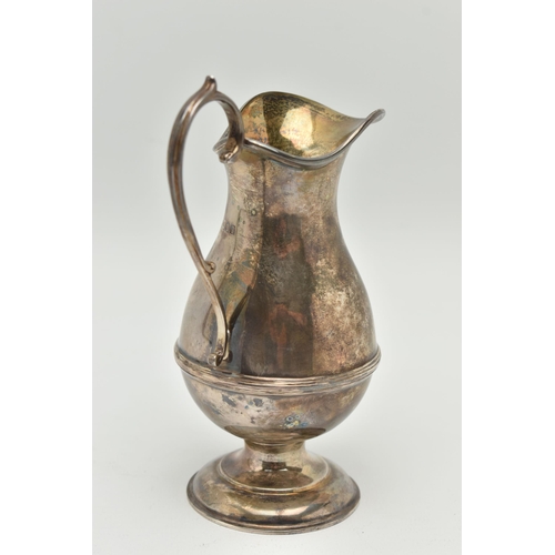 184 - A GEORGE V SILVER CREAM JUG, a baluster form jug with a scrolling handle, approximate height 145mm, ... 