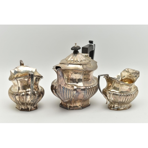 185 - AN EDWARD VII THREE PIECE SILVER TEA SET, comprising of a Queen Anne style tea pot, milk jug and sug... 